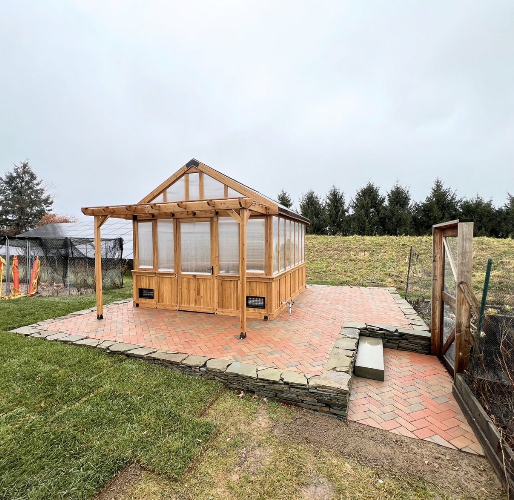 Finished cedar greenhouse with paver patio