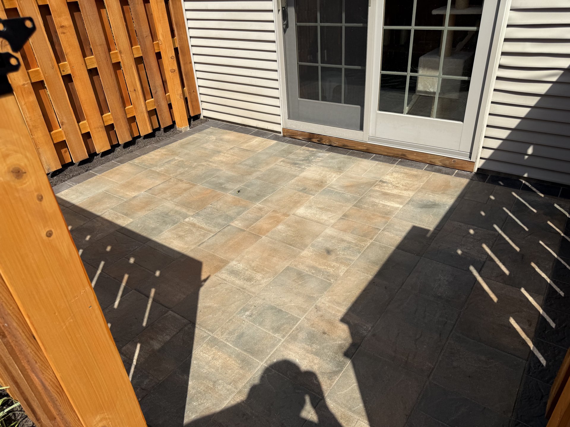 Finished paver patio looking toward fence